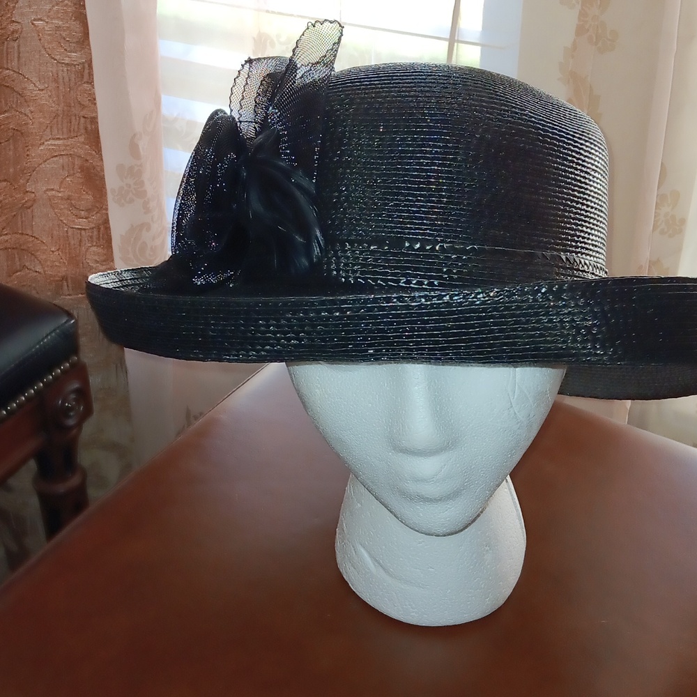 Ladies black hat with net bow and pin accent.